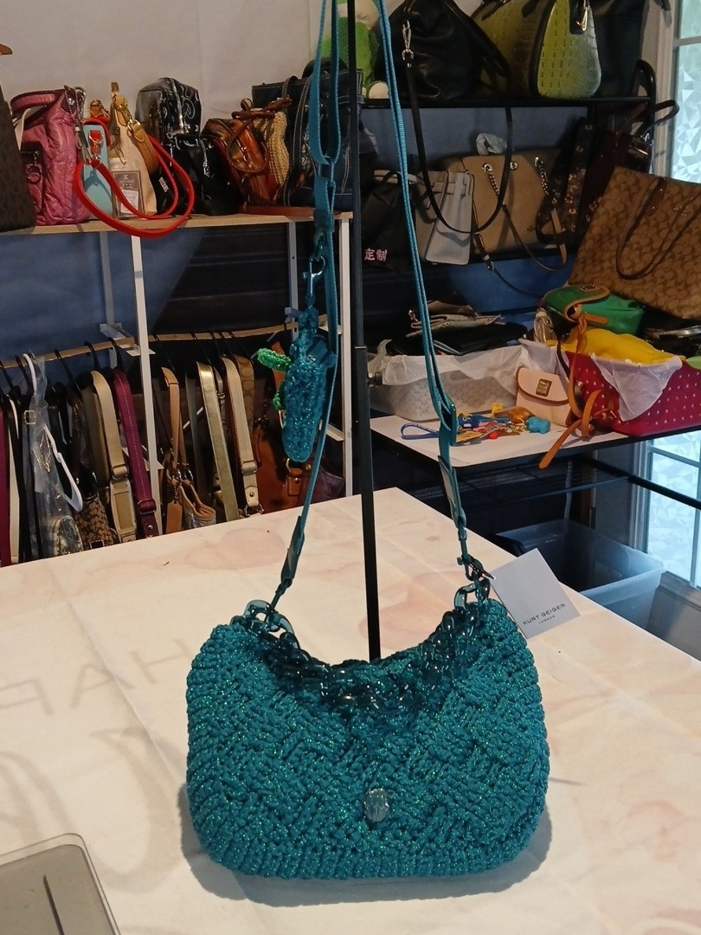 Kurt Geiger teal crochet crossbody bag, translucent chain strap & dust bag